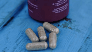 Magic Mushroom Capsules on blue wood